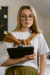 Woman Wearing Eyeglasses Holding a Tablet Computer