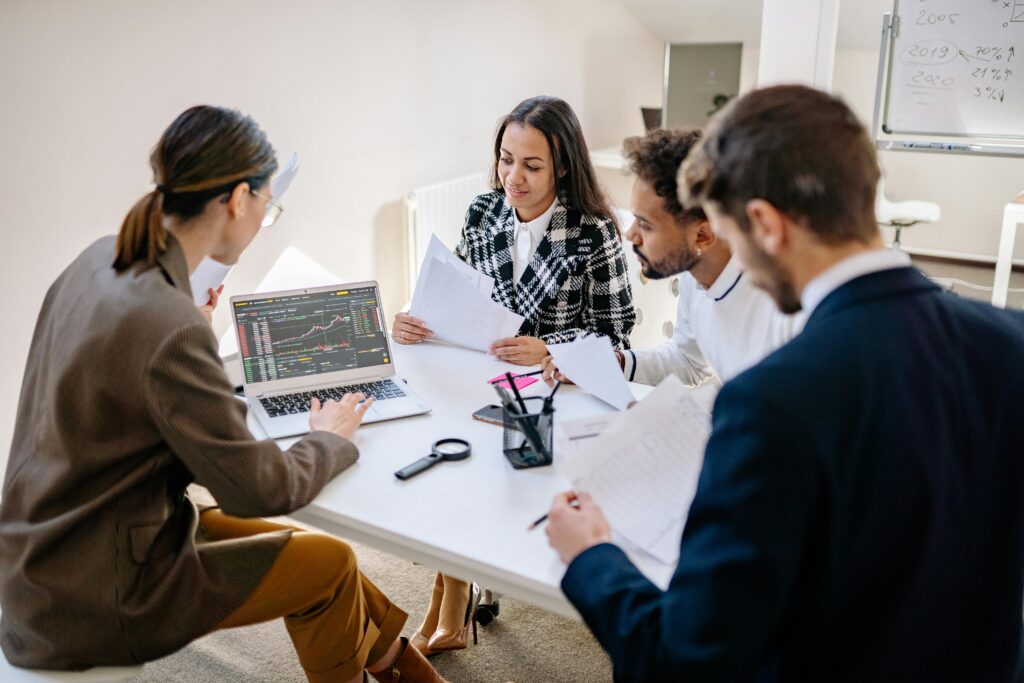 Coworkers Looking at a Laptop in a Meeting