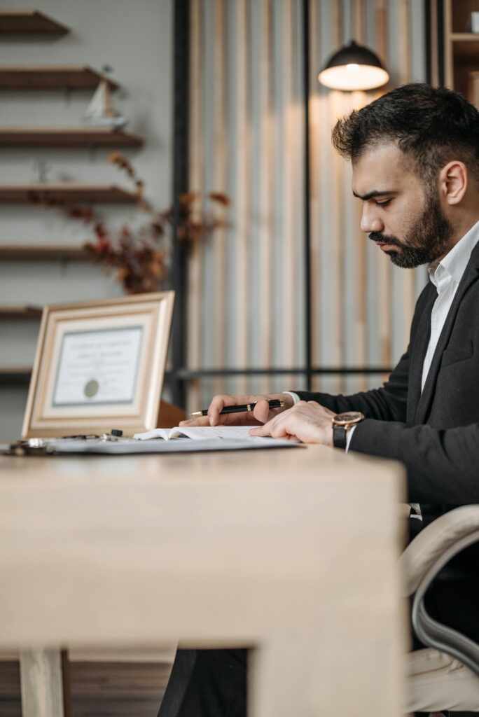 Man Sitting by Desk and Working